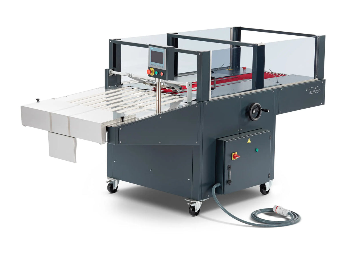 Machine plieuse textile STP1000 avec panneau de commande tactile, équipement industriel pour pliage automatique de vêtements.